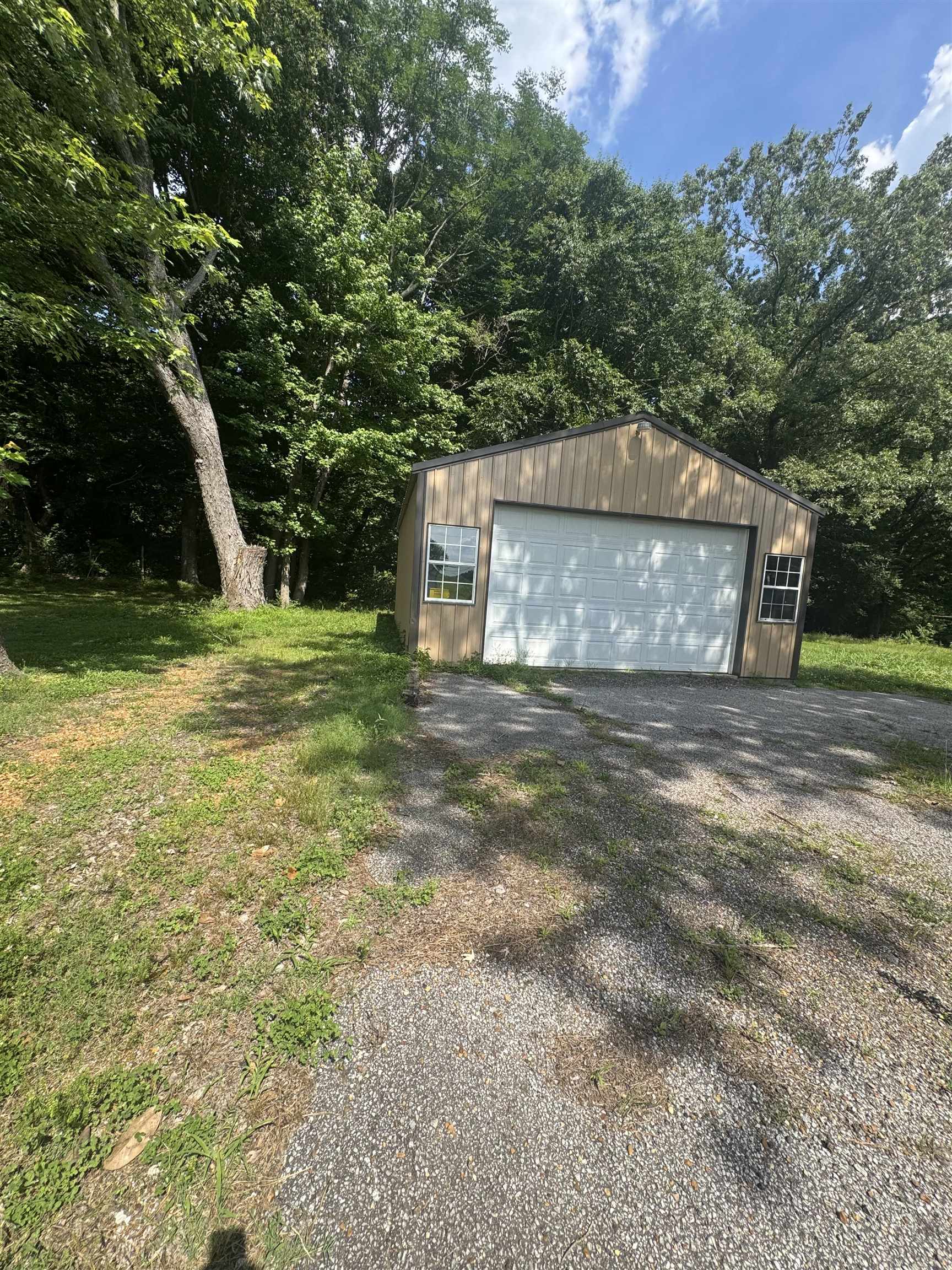 106 Cole Road Drummonds, TN 38023 - Photo 10 of 21 Freestanding garage with a light-toned wood-finish exterior and a white overhead door
