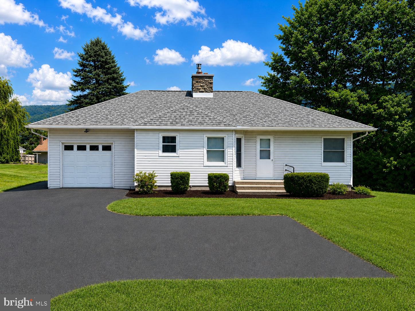 Charming home with lush green surroundings.