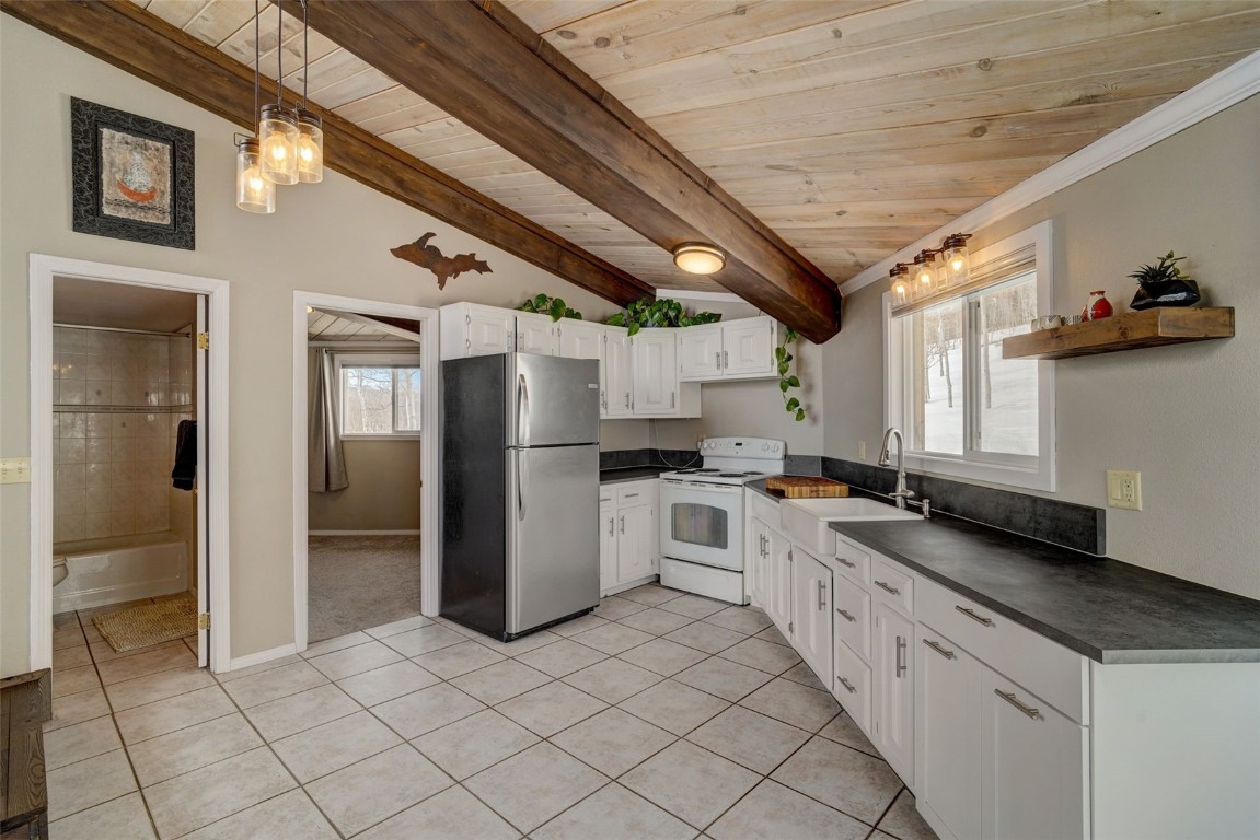 433 P Road Dillon, CO 80435 - Photo 9 of 20 a kitchen with granite countertop a refrigerator and a sink