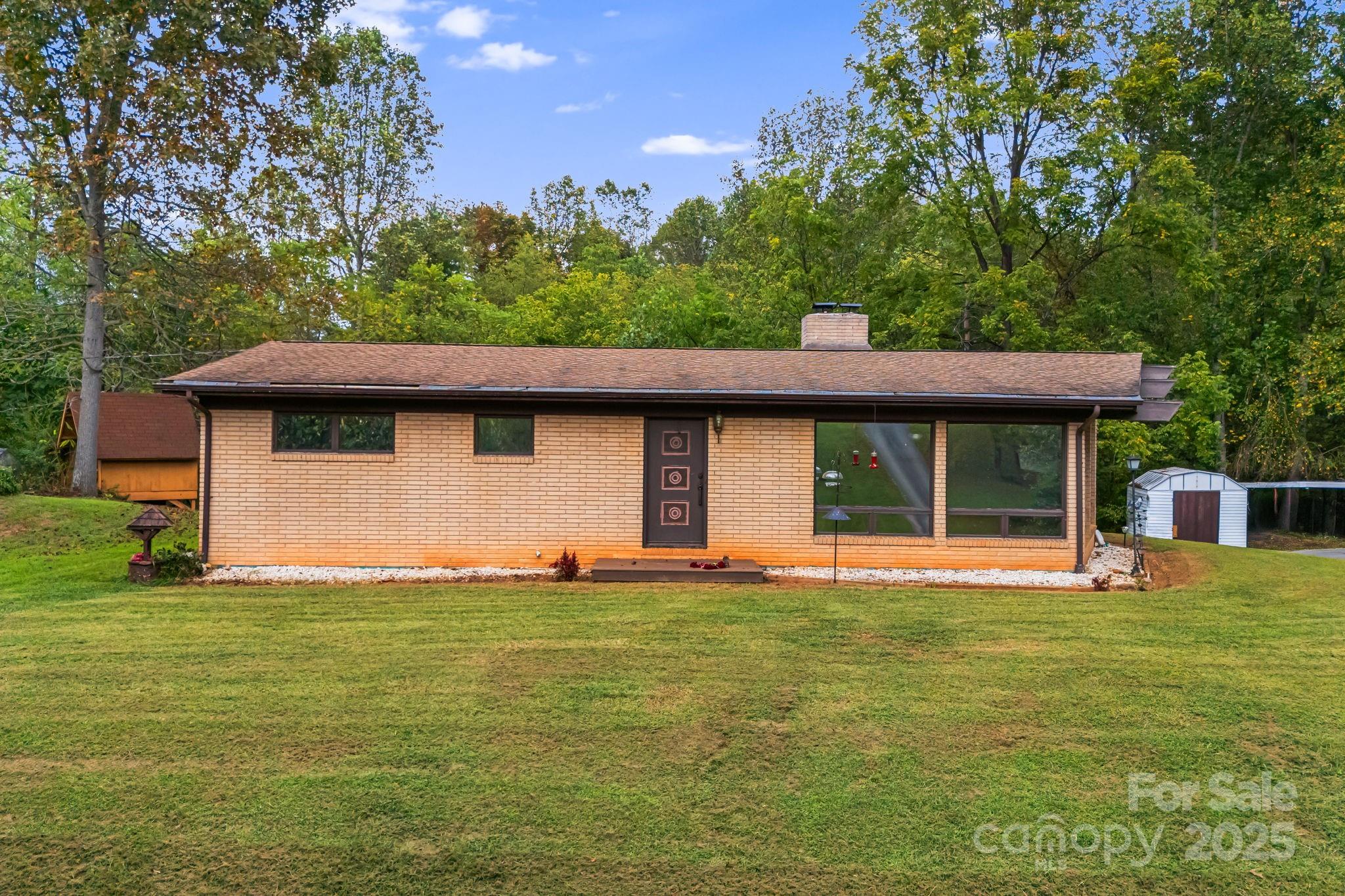 18 Bianca Way Alexander, NC 28701 - Photo 6 of 30 a front view of a house with a yard and trees