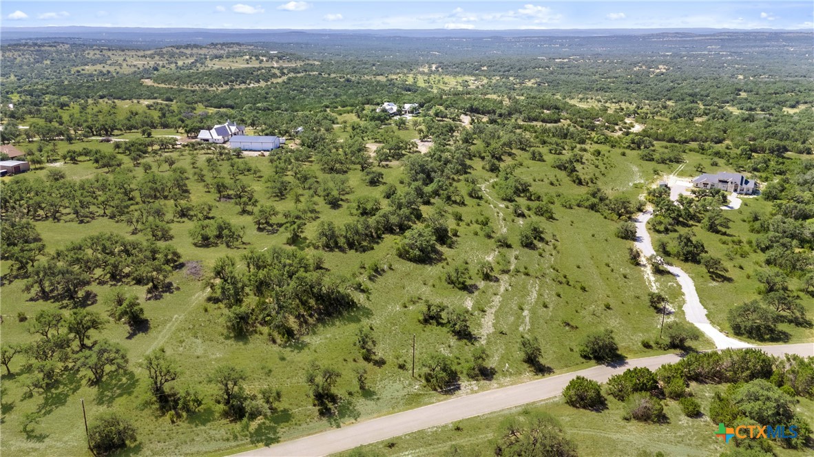 820 Stone Ridge Mountain Drive Round Mountain, TX 78663 - Photo 27 of 32 a view of a city with green field