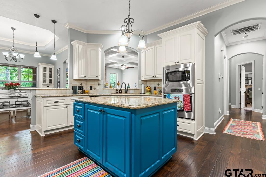 449 Greenhill Road Longview, TX 75605 - Photo 13 of 48 a kitchen with kitchen island granite countertop a sink stainless steel appliances and cabinets