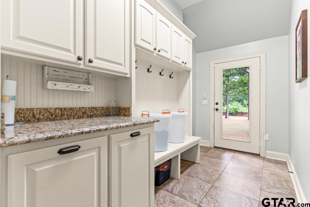 449 Greenhill Road Longview, TX 75605 - Photo 30 of 48 a bathroom with a granite countertop sink a mirror and a bathtub