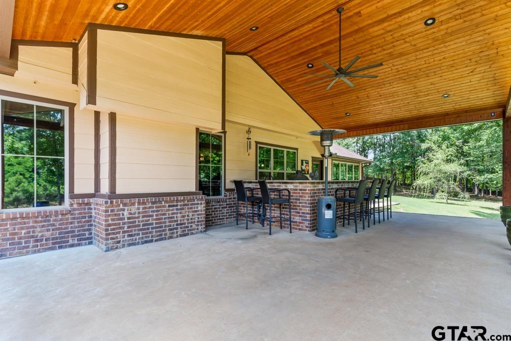 449 Greenhill Road Longview, TX 75605 - Photo 35 of 48 a view of a patio with table and chairs and wooden fence