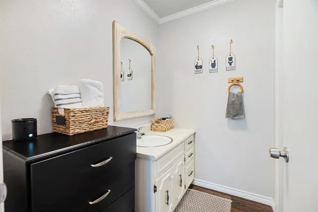 a bedroom with a bed a dresser and a chair