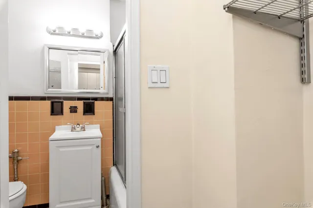 a bathroom with a sink mirror toilet and vanity