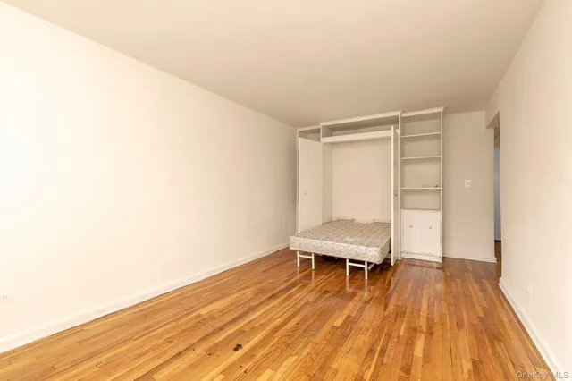 a view of a room with wooden floor