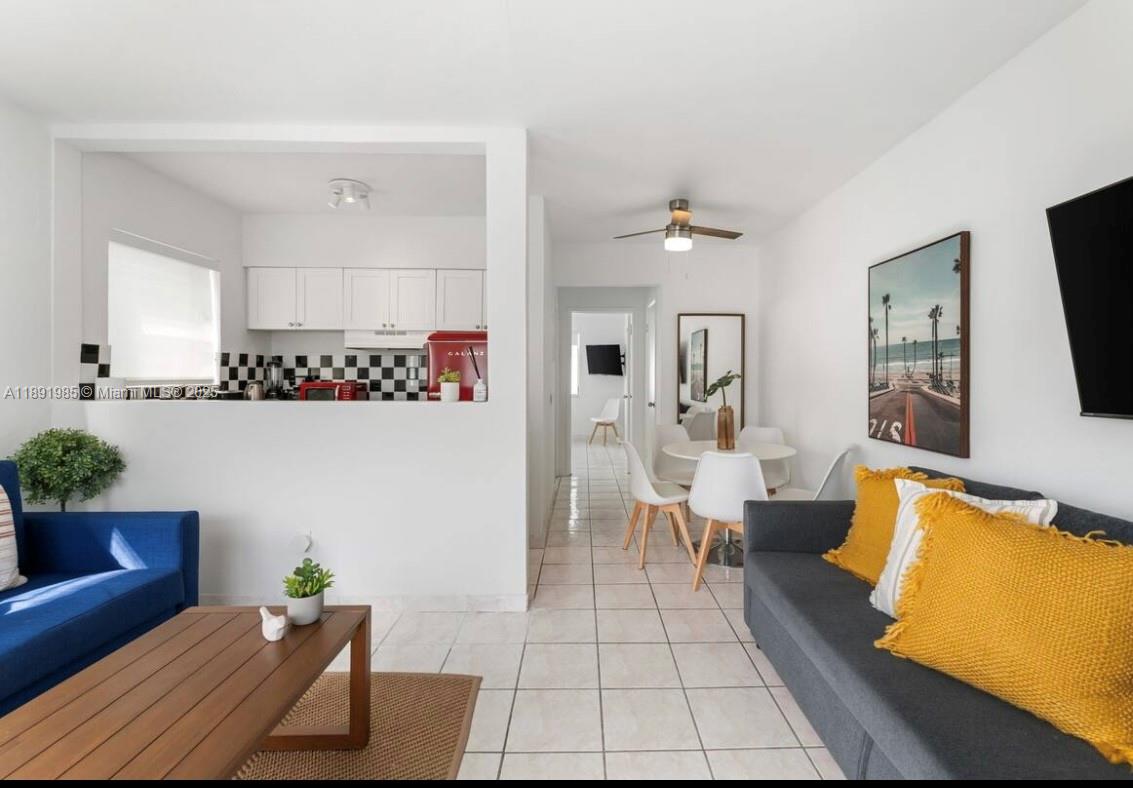 7721 Harding Avenue, Unit 8 Miami Beach, FL 33141 - Photo 1 of 14 a living room with furniture and a flat screen tv