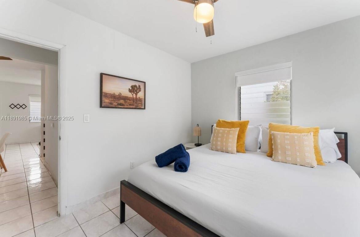 7721 Harding Avenue, Unit 8 Miami Beach, FL 33141 - Photo 12 of 14 a bedroom with a bed and a painting on the wall