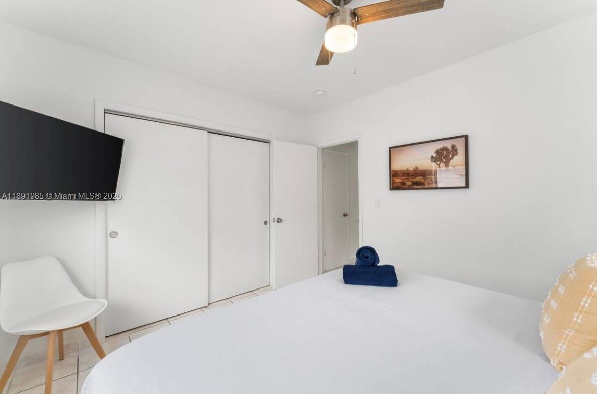 7721 Harding Avenue, Unit 8 Miami Beach, FL 33141 - Photo 13 of 14 a living room with a couch and a flat screen tv