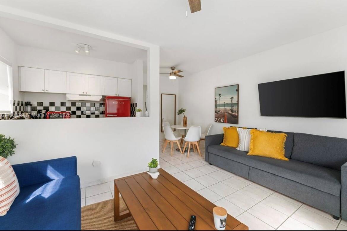 7721 Harding Avenue, Unit 8 Miami Beach, FL 33141 - Photo 4 of 14 a living room with furniture and a flat screen tv