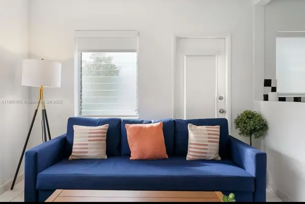 a living room with furniture and a potted plant