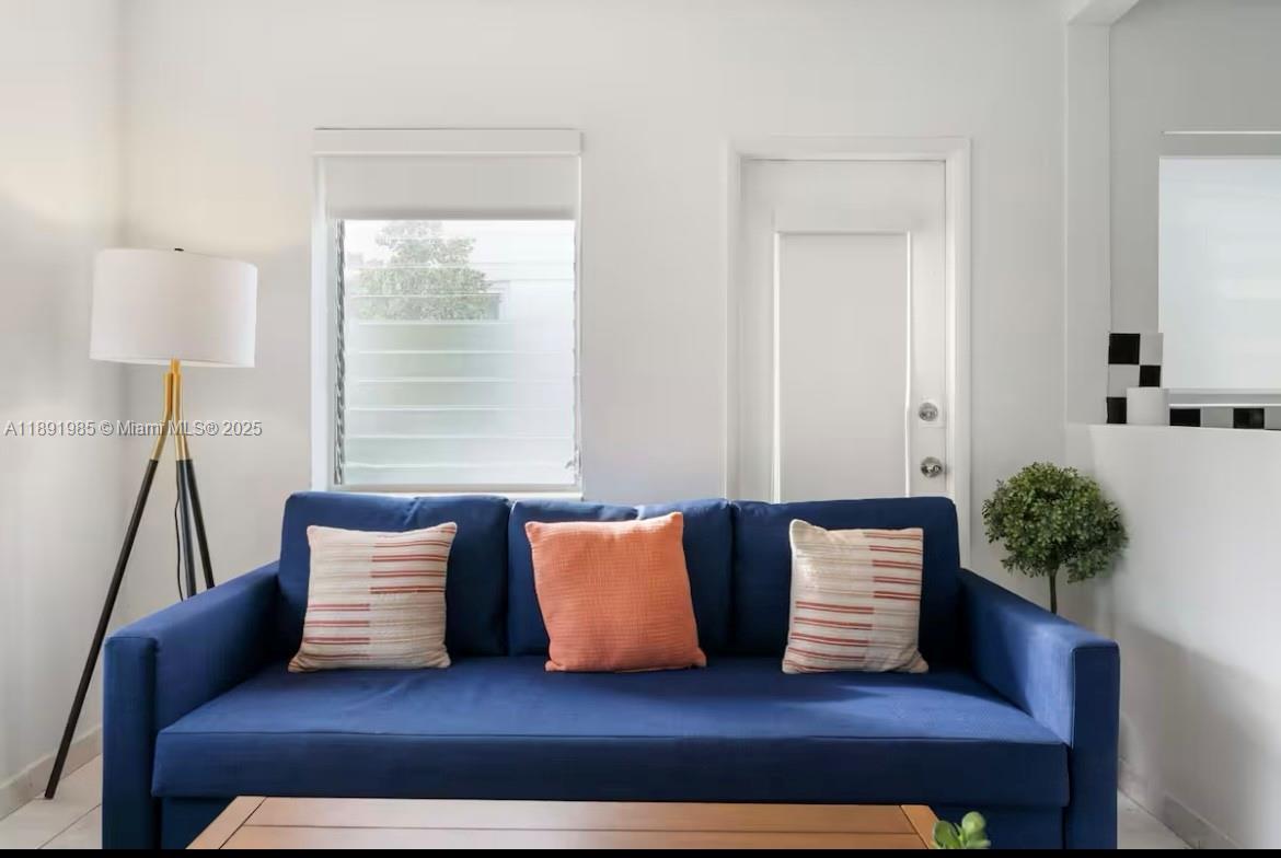 7721 Harding Avenue, Unit 8 Miami Beach, FL 33141 - Photo 5 of 14 a living room with furniture and a potted plant