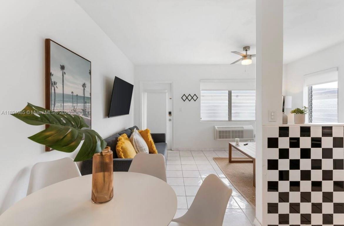7721 Harding Avenue, Unit 8 Miami Beach, FL 33141 - Photo 9 of 14 a living room with furniture and a flat screen tv