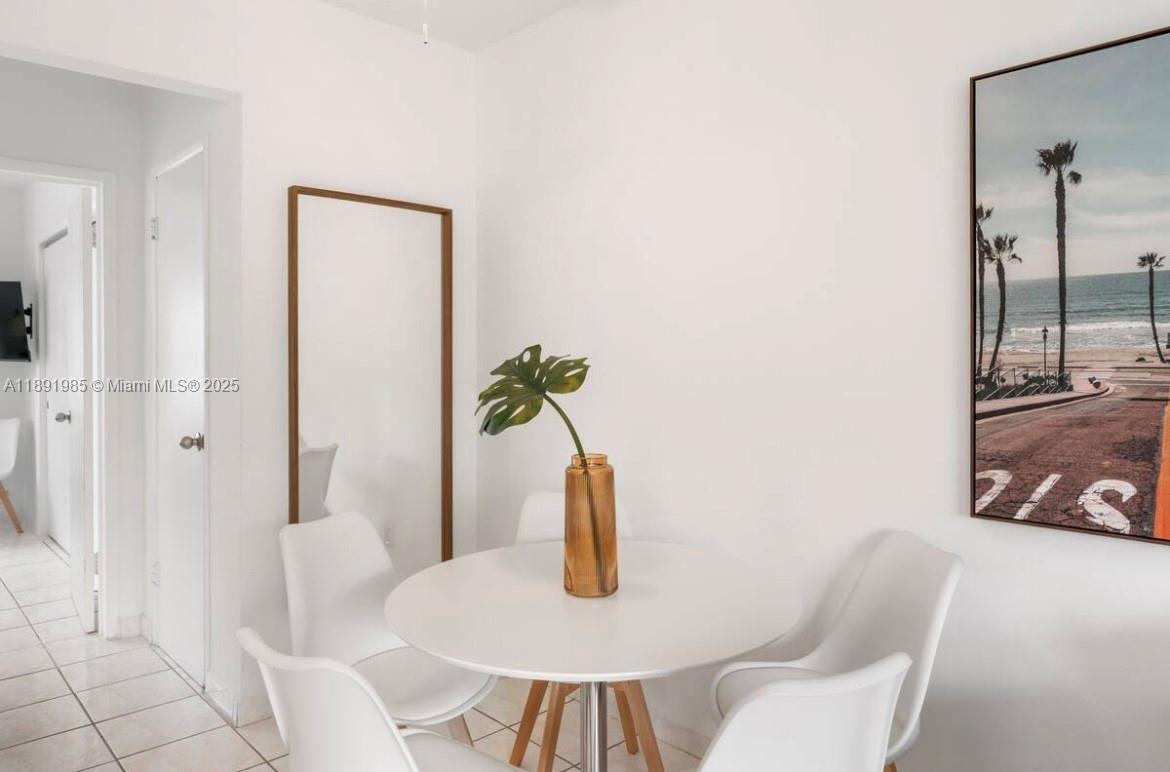 7721 Harding Avenue, Unit 8 Miami Beach, FL 33141 - Photo 10 of 14 a view of a dining room with furniture and wooden floor