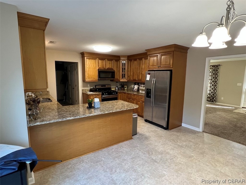 108 Hill Crest Road Wake, VA 23176 - Photo 7 of 21 Kitchen featuring light tile flooring, pendant lighting, stainless steel appliances, and a notable chandelier