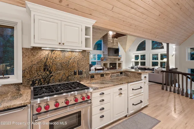 a kitchen with stainless steel appliances granite countertop a stove and a sink