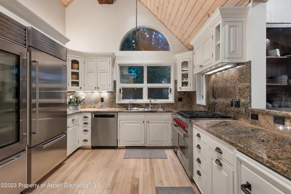 a kitchen with a sink stove and refrigerator