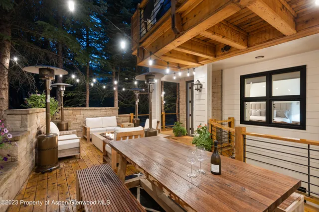 a outdoor space with lots of tables a garden view and living room