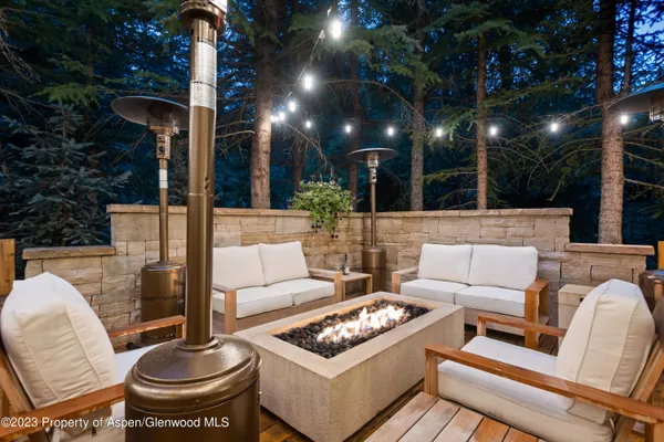 a view of a patio with couches table and chairs and potted plants