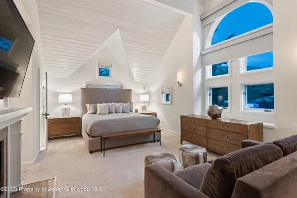 a bedroom with furniture and a flat screen tv