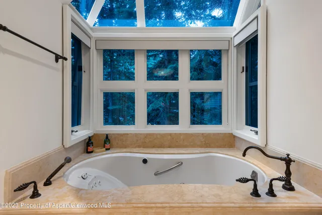a bathroom with bathtub and window