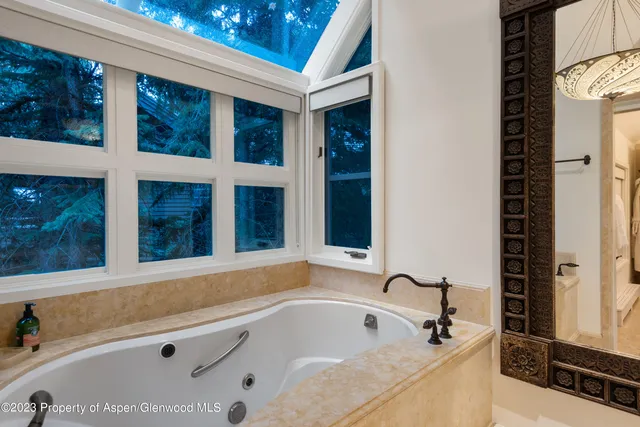 a bathroom with bathtub and window