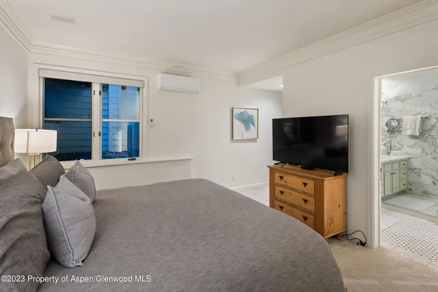 a bedroom with furniture and a flat screen tv