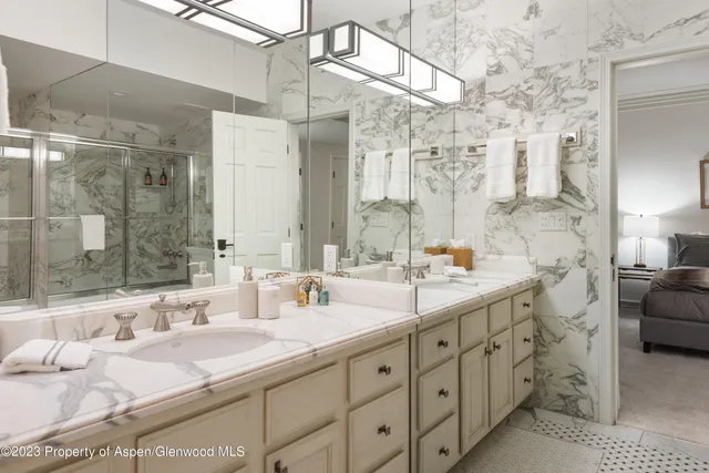 a bathroom with double vanity sink and a mirror