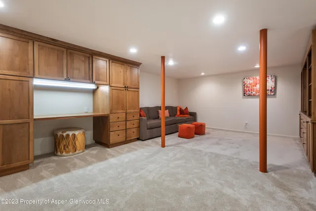 a kitchen with refrigerator and more cabinets