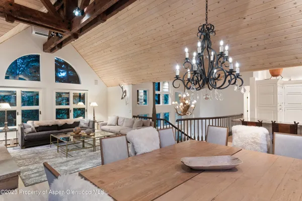 a bedroom with furniture and a chandelier