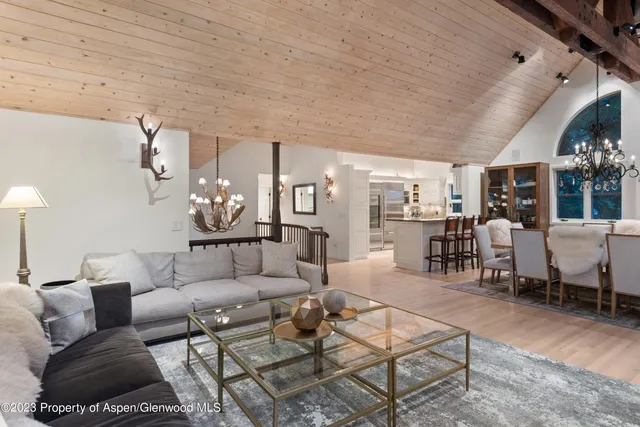 a living room with furniture and a chandelier