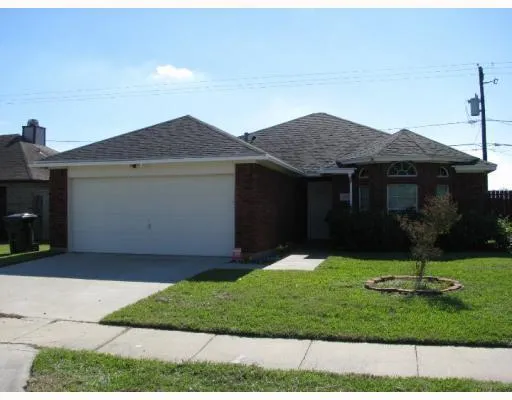 a view of a house with a yard and plants