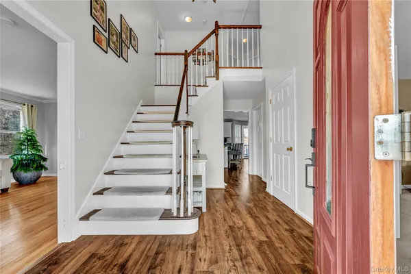 a view of entryway with wooden floor and stairs
