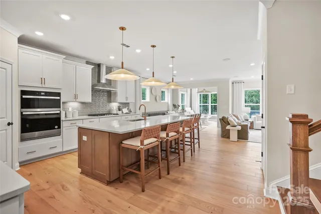 a large kitchen with a table and chairs