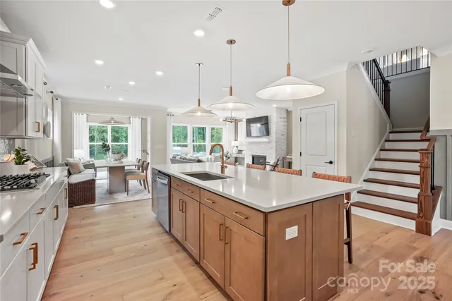a kitchen with stainless steel appliances a sink stove and refrigerator