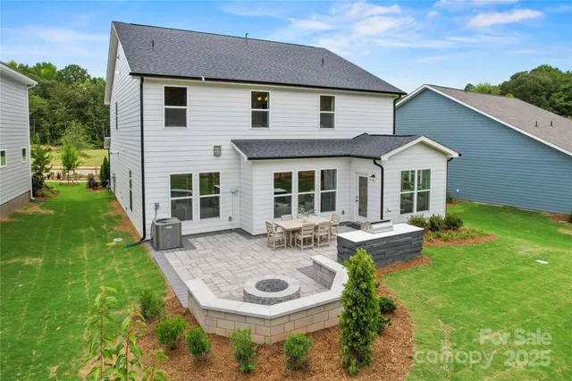 a view of a house with backyard sitting area and garden