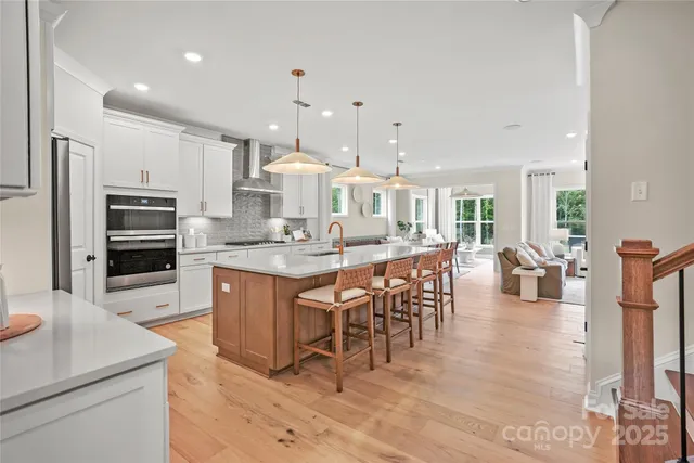 a large kitchen with a table and chairs