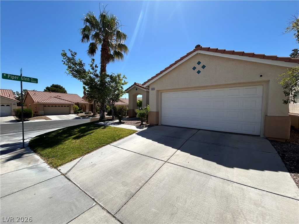 1840 Montvale Las Vegas, NV 89134 - Photo 2 of 31 A desert oasis, this property features a concrete driveway, attached garage, and tiled roof.