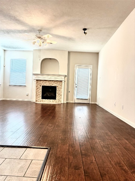 20518 Bonds Creek Lane Spring, TX 77388 - Photo 12 of 30 an empty room with wooden floor fireplace and windows