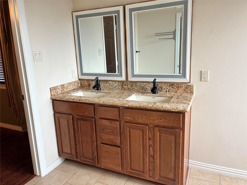 20518 Bonds Creek Lane Spring, TX 77388 - Photo 21 of 30 a bathroom with a granite countertop sink and a mirror