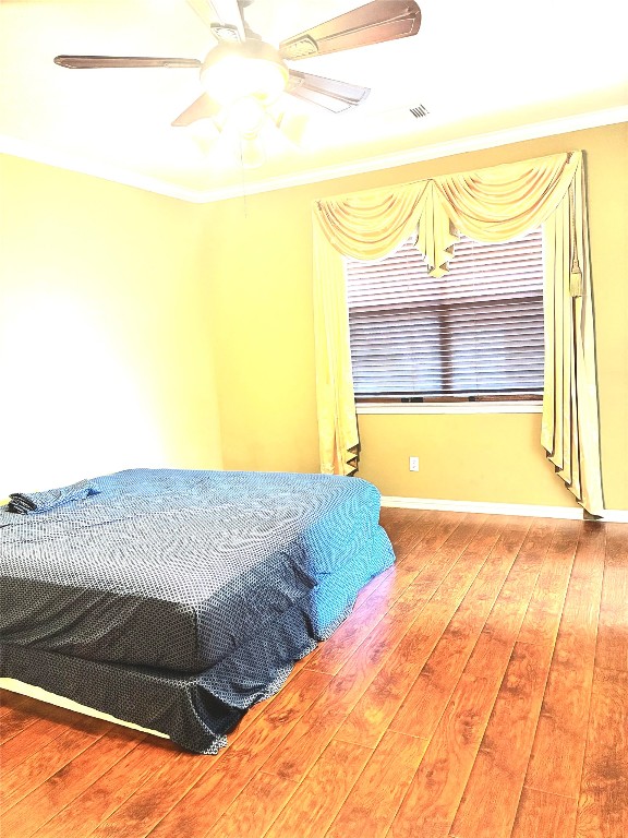 20518 Bonds Creek Lane Spring, TX 77388 - Photo 25 of 30 a bedroom with a bed and wooden floor