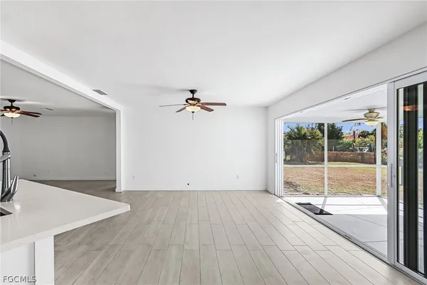 a view of a room with wooden floor and fan