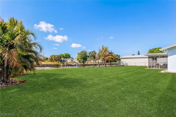 an aerial view of a house with swimming pool and lake view