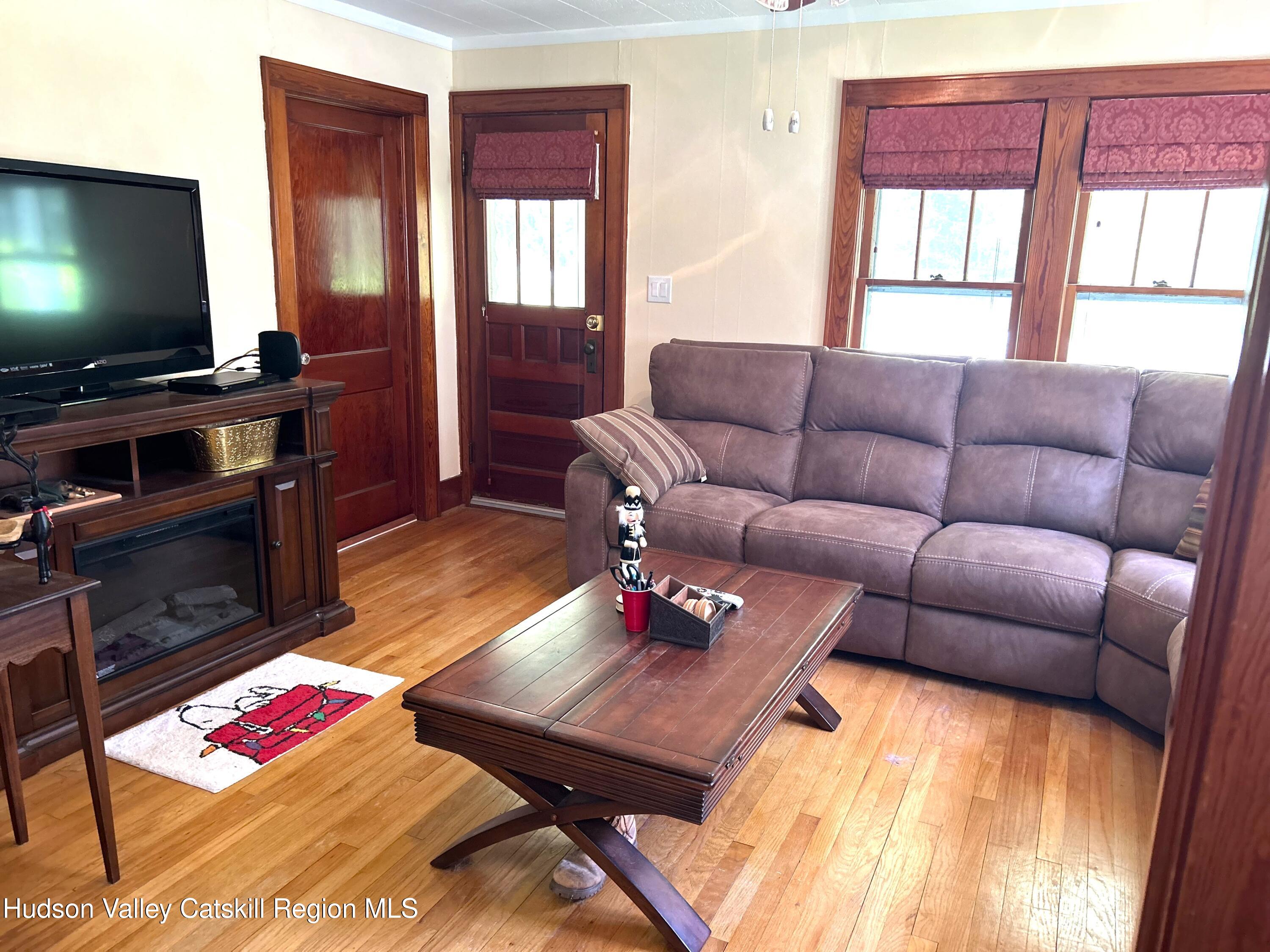 169 Rt 4 Prattsville, NY 12468 - Photo 8 of 43 a living room with furniture and a flat screen tv