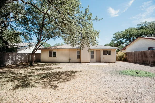 a house that has a tree in front of it