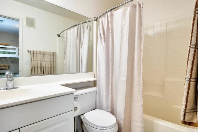 a bedroom with a bed and lamps