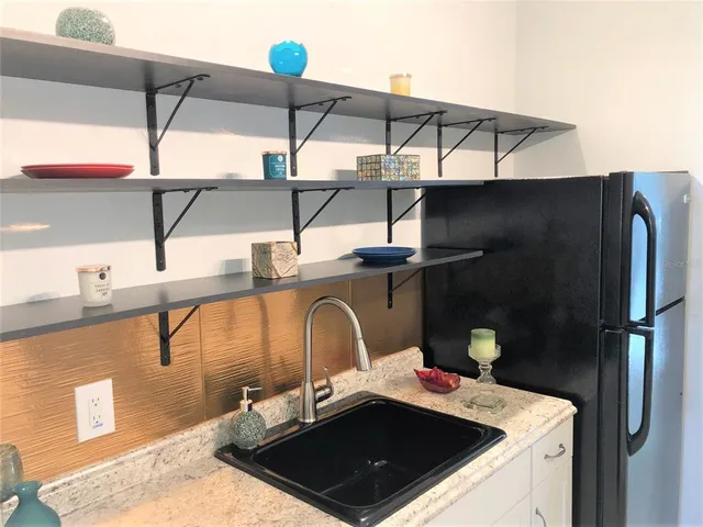 a bathroom with a sink a mirror and cabinets