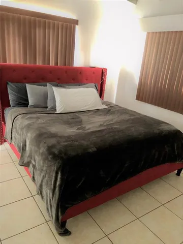 a bedroom with a bed and a cabinets