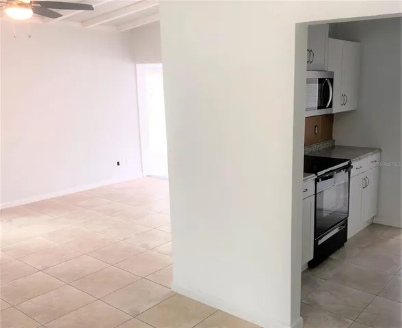 a view of a hallway with entryway window and front door